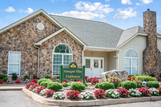 a view of a house with pool and chairs