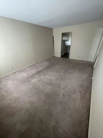 a view of an empty room with windows