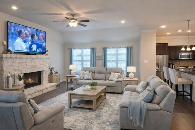 a living room with furniture a fireplace and a flat screen tv