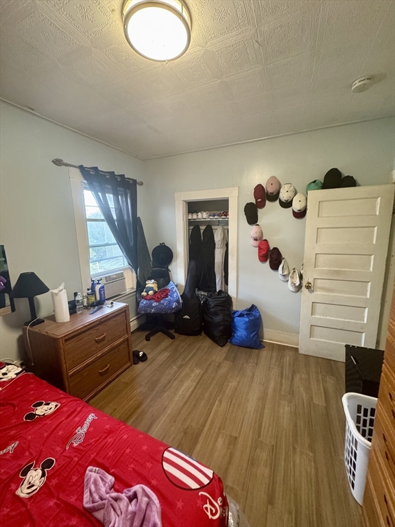 57-59 Walnut Street Lawrence, MA 01841 - Photo 18 of 23 a bedroom with furniture and a wooden floor