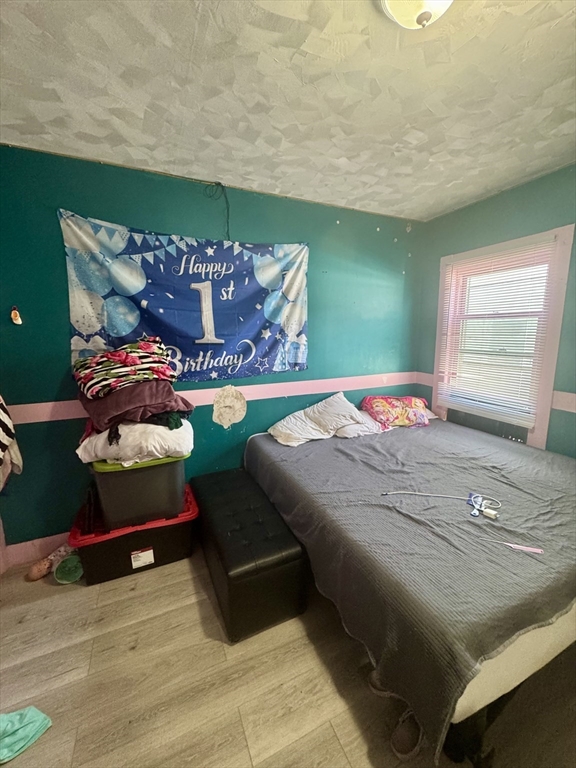 57-59 Walnut Street Lawrence, MA 01841 - Photo 19 of 23 a bedroom with a bed and window