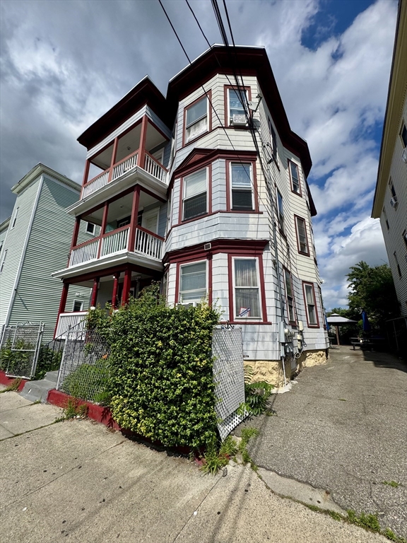 57-59 Walnut Street Lawrence, MA 01841 - Photo 2 of 23 a front view of a multi story residential apartment building