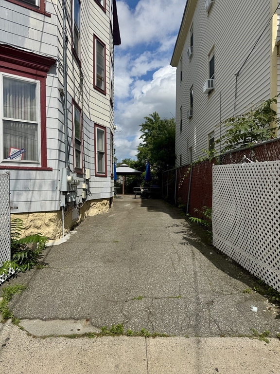 57-59 Walnut Street Lawrence, MA 01841 - Photo 3 of 23 a view of a house with a yard and sitting area