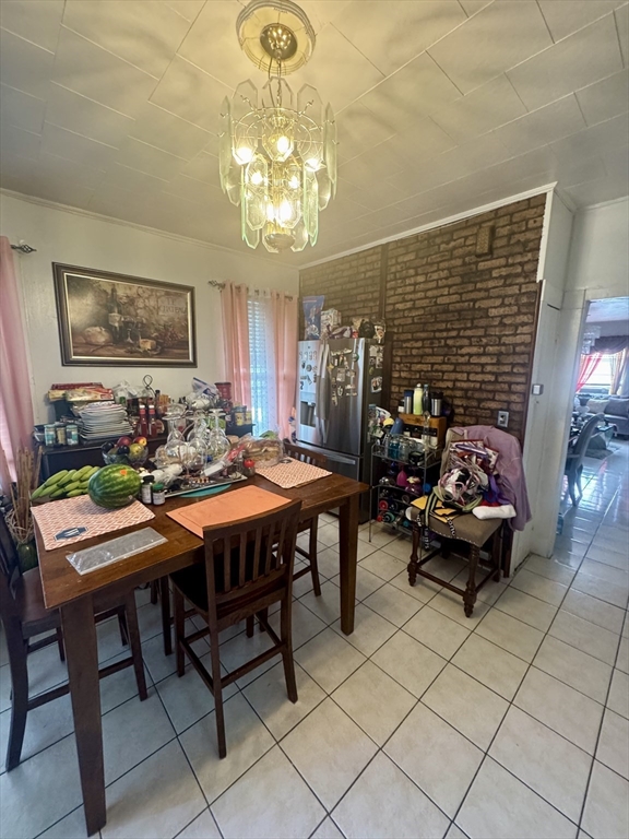 57-59 Walnut Street Lawrence, MA 01841 - Photo 7 of 23 a view of a dining room with furniture a chandelier and window