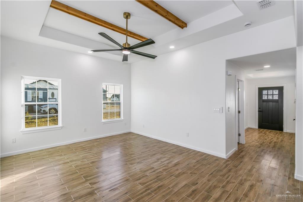 2309 Victoriano Street Weslaco, TX 78596 - Photo 4 of 15 a view of an empty room with a window and wooden floor