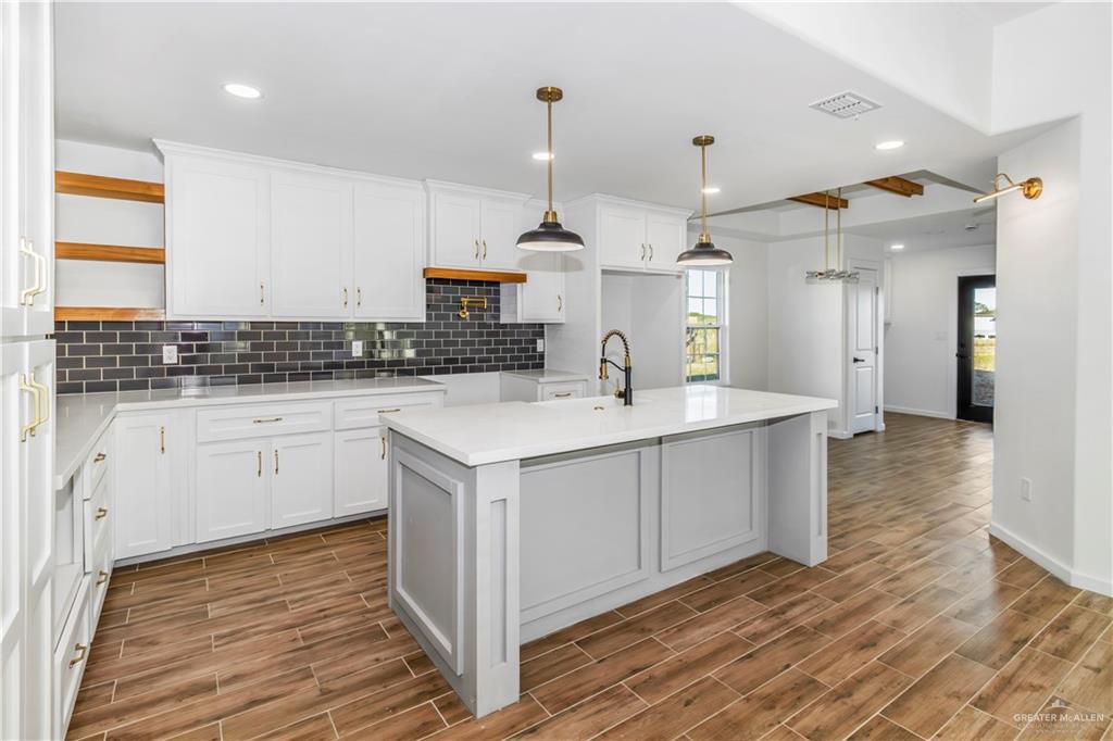 2309 Victoriano Street Weslaco, TX 78596 - Photo 5 of 15 a kitchen with white cabinets and sink