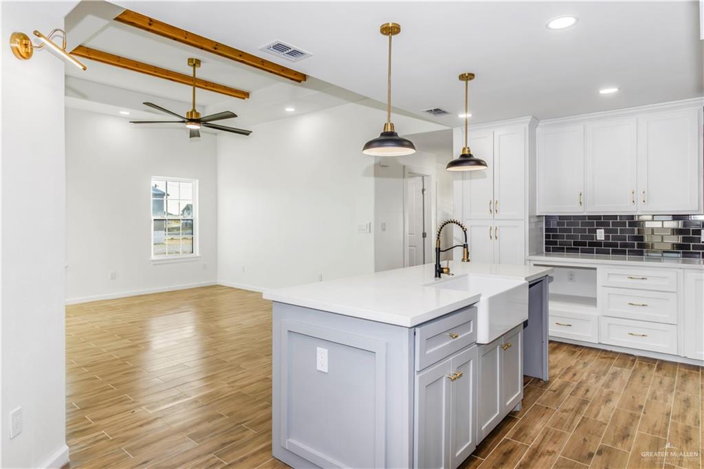 2309 Victoriano Street Weslaco, TX 78596 - Photo 6 of 15 a kitchen with a sink a stove and cabinets