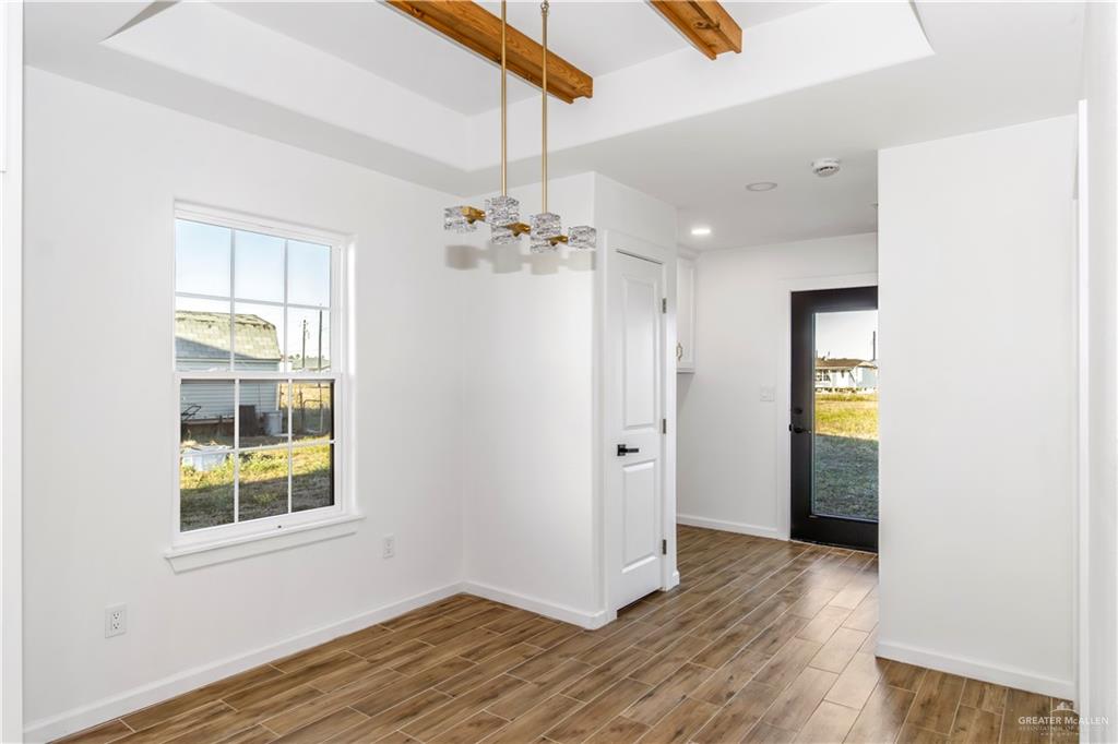 2309 Victoriano Street Weslaco, TX 78596 - Photo 8 of 15 a view of an empty room with wooden floor and a window