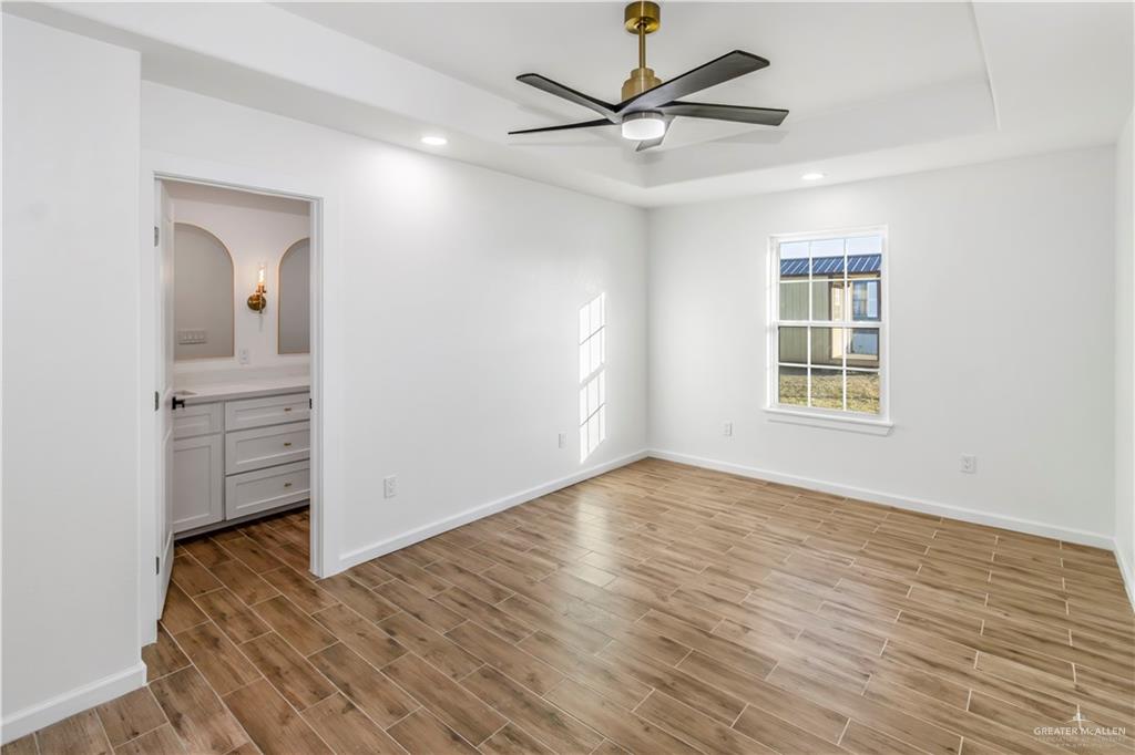 2309 Victoriano Street Weslaco, TX 78596 - Photo 10 of 15 wooden floor in an empty room with a window