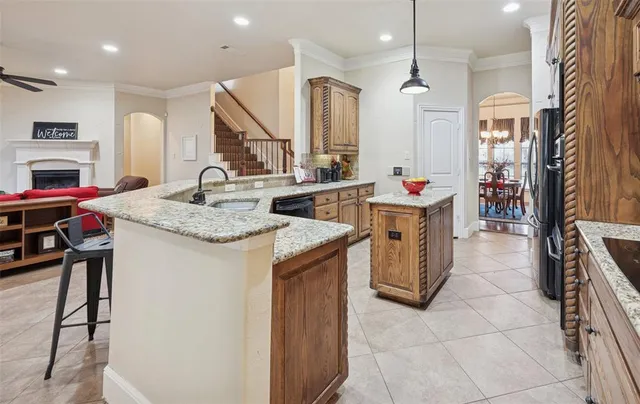 a kitchen with a sink a counter and chairs