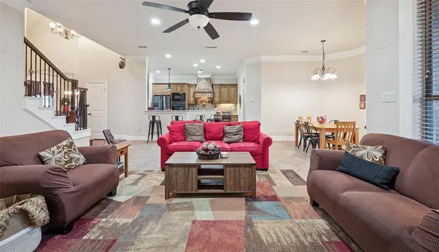 a living room with furniture and kitchen view