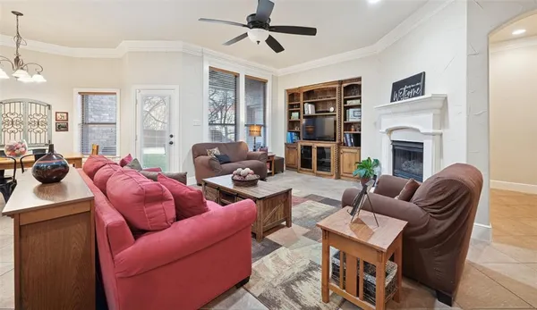 a living room with furniture a fireplace and a window
