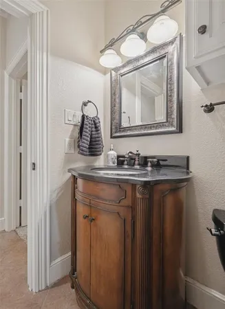 a bathroom with a granite countertop sink a mirror and vanity
