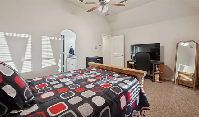 a bedroom with a bed and a chandelier