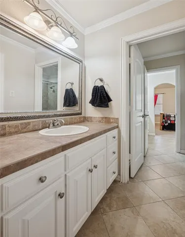 a spacious bathroom with a double vanity sink and a mirror