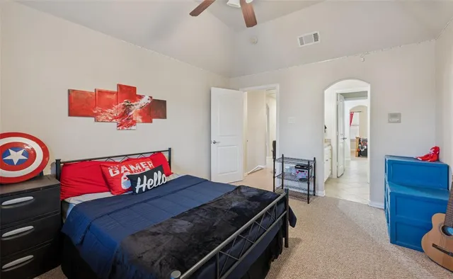 a bedroom with a bed and a chandelier