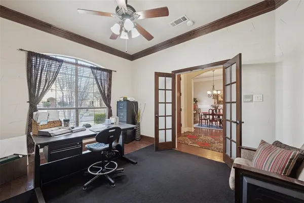 a view of a workspace with furniture and a window