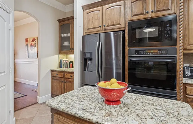 a kitchen with a refrigerator and a stove