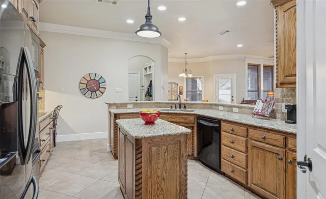 a kitchen with stainless steel appliances granite countertop a sink and cabinets