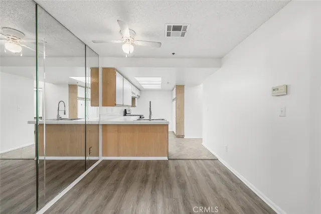 a view of kitchen with sink and wooden floor