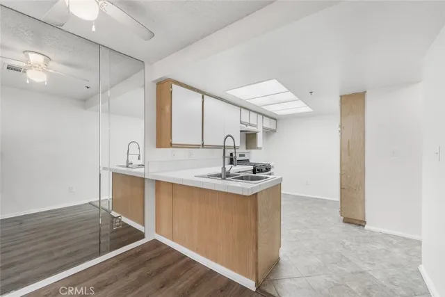 a kitchen with stainless steel appliances a sink stove and cabinets