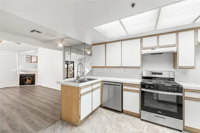 a kitchen with stainless steel appliances granite countertop a stove and a sink