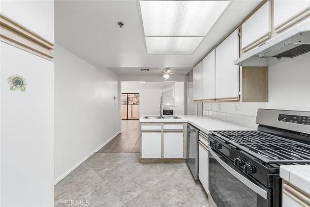 a kitchen with a sink stove and cabinets