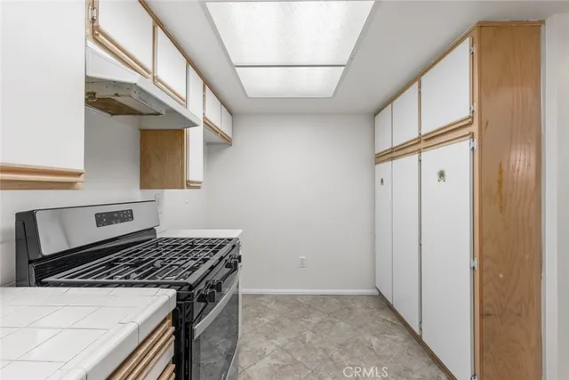 a kitchen with stainless steel appliances granite countertop a stove and a refrigerator
