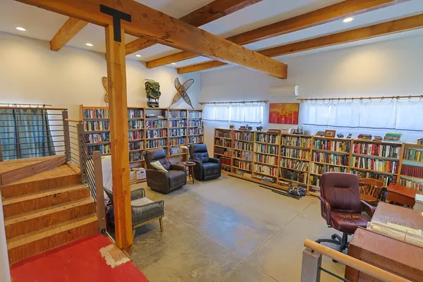 a reading room with furniture and a book shelf