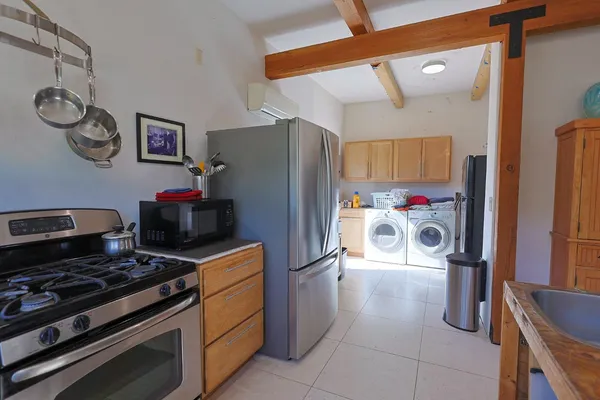 a kitchen with stainless steel appliances granite countertop a refrigerator and a stove top oven