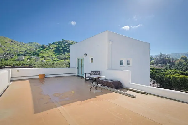 a view of a terrace with hardwood and floor to ceiling window