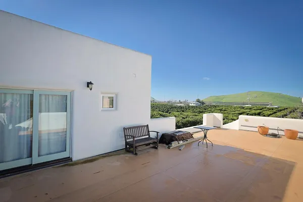 a balcony with furniture and city view