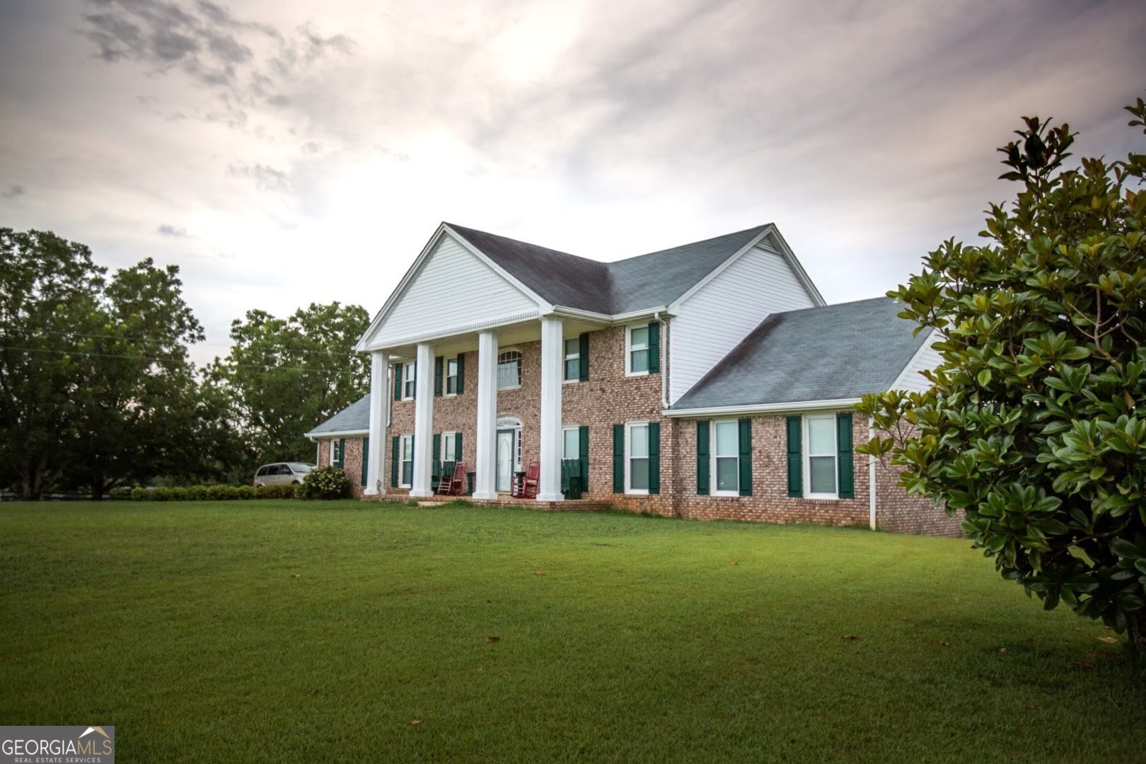 1530 State Highway 11 Covington, GA 30014 - Photo 2 of 32 a front view of a house with a garden and trees