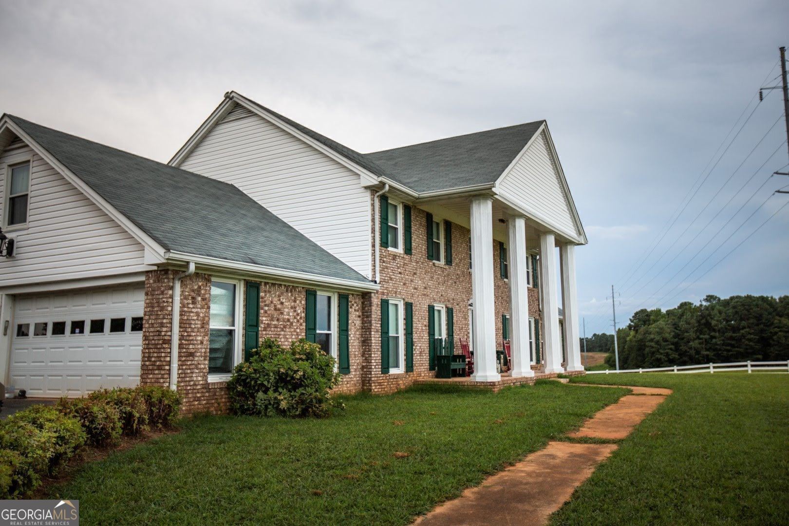 1530 State Highway 11 Covington, GA 30014 - Photo 4 of 32 a front view of a house with a yard and garage