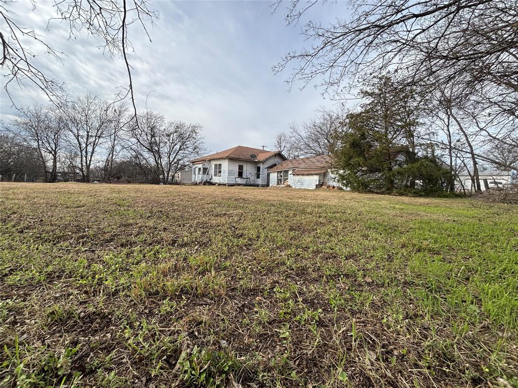 103 West 3rd Street Barry, TX 75102 - Photo 23 of 40 a big yard with trees in front of it