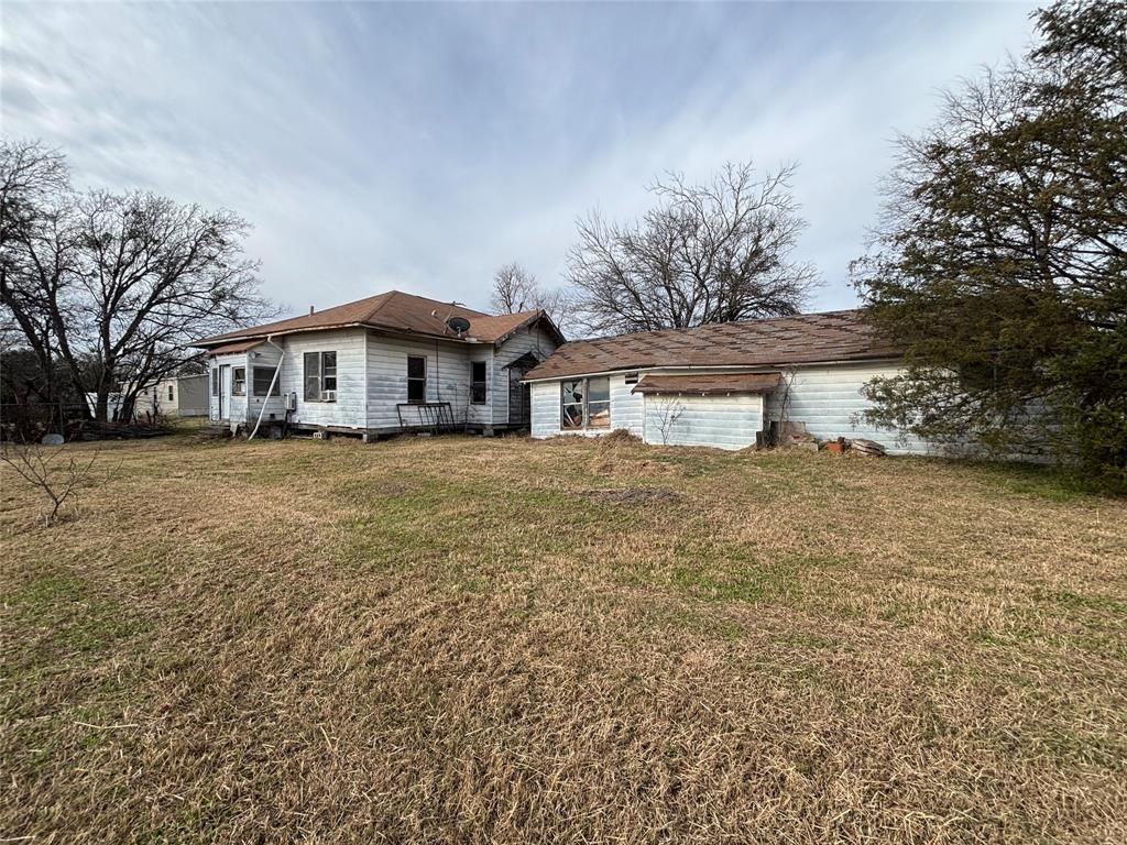 103 West 3rd Street Barry, TX 75102 - Photo 24 of 40 a front view of a house with a yard