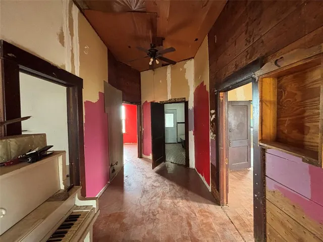 a view of a livingroom with a ceiling fan and window