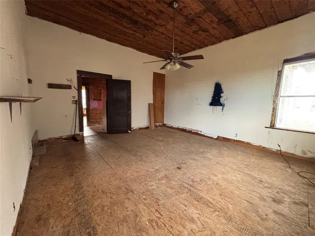 a view of a patio with a table and chairs