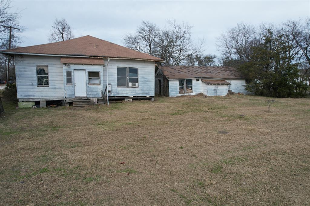 103 West 3rd Street Barry, TX 75102 - Photo 8 of 40 a big house with a big yard and large trees