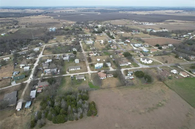 an aerial view of residential houses with city view