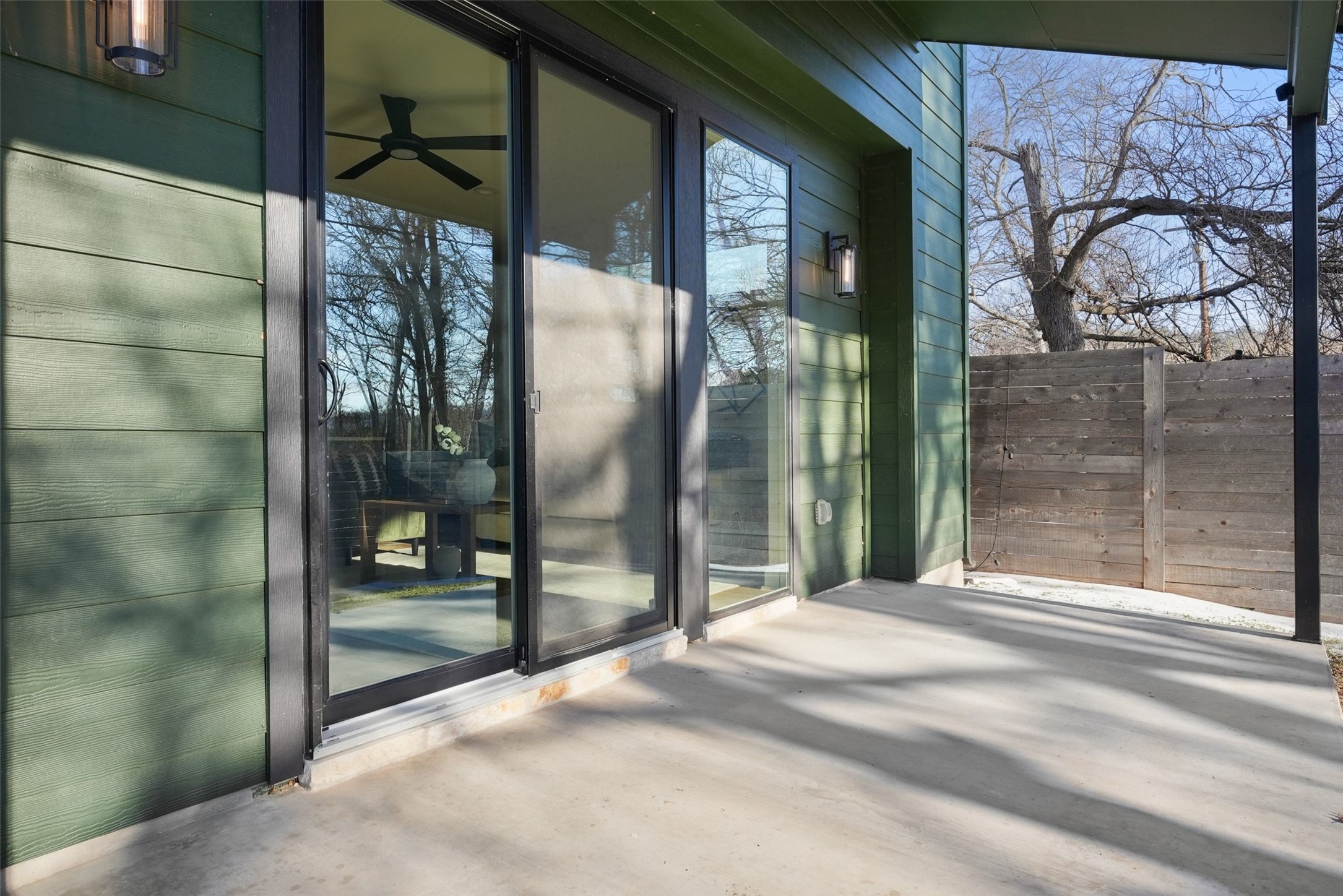 5109 Stone Gate Drive, Unit 2 Austin, TX 78721 - Photo 34 of 36 Expansive concrete patio area with a wooden privacy fence
