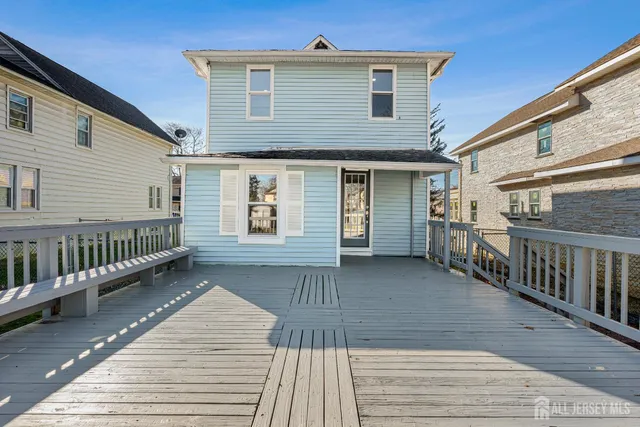 a view of a house with wooden deck