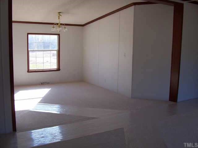 4549 Brantley Road Zebulon, NC 27597 - Photo 4 of 7 a view of a window in an empty room