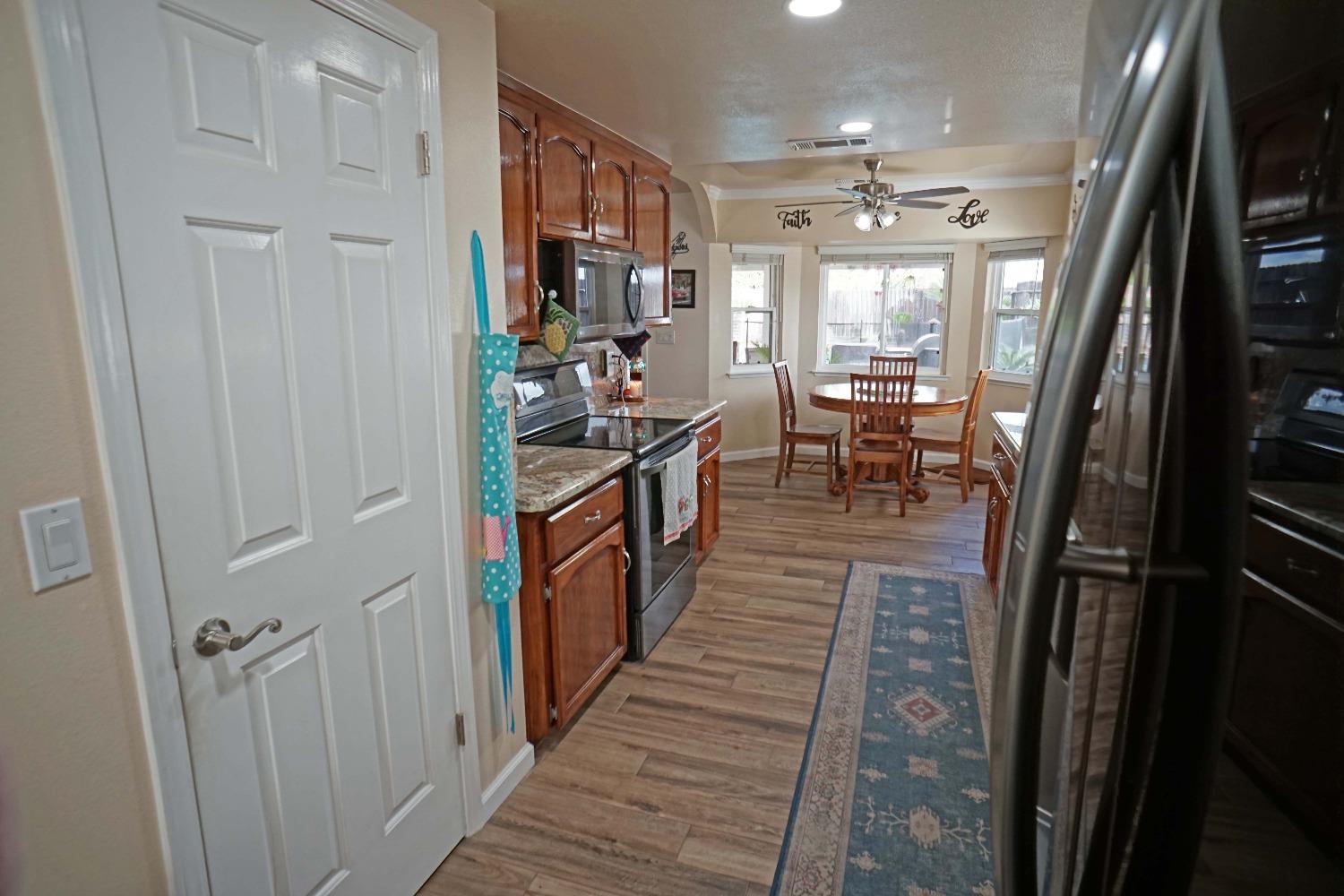 2197 Polson Avenue Clovis, CA 93611 - Photo 11 of 42 a view of a hallway with wooden floor and a living room