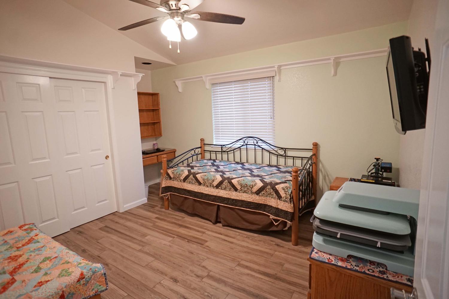 2197 Polson Avenue Clovis, CA 93611 - Photo 18 of 42 a bedroom with a bed and a chandelier