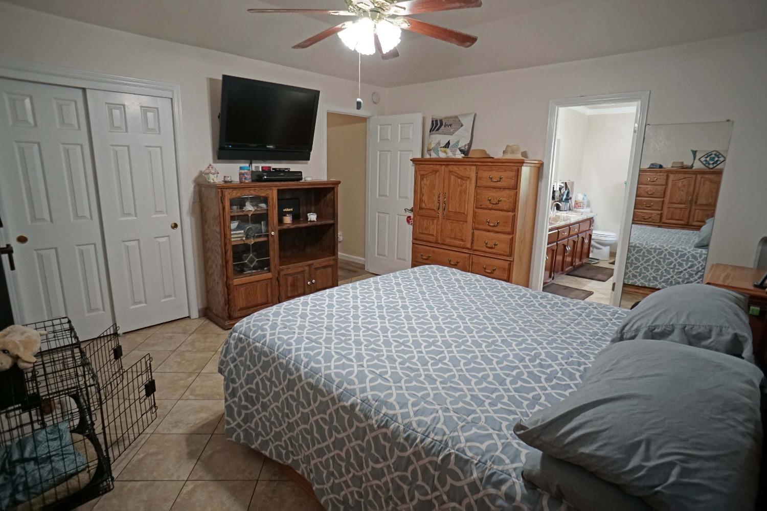 2197 Polson Avenue Clovis, CA 93611 - Photo 26 of 42 a bedroom with a bed and a flat screen tv