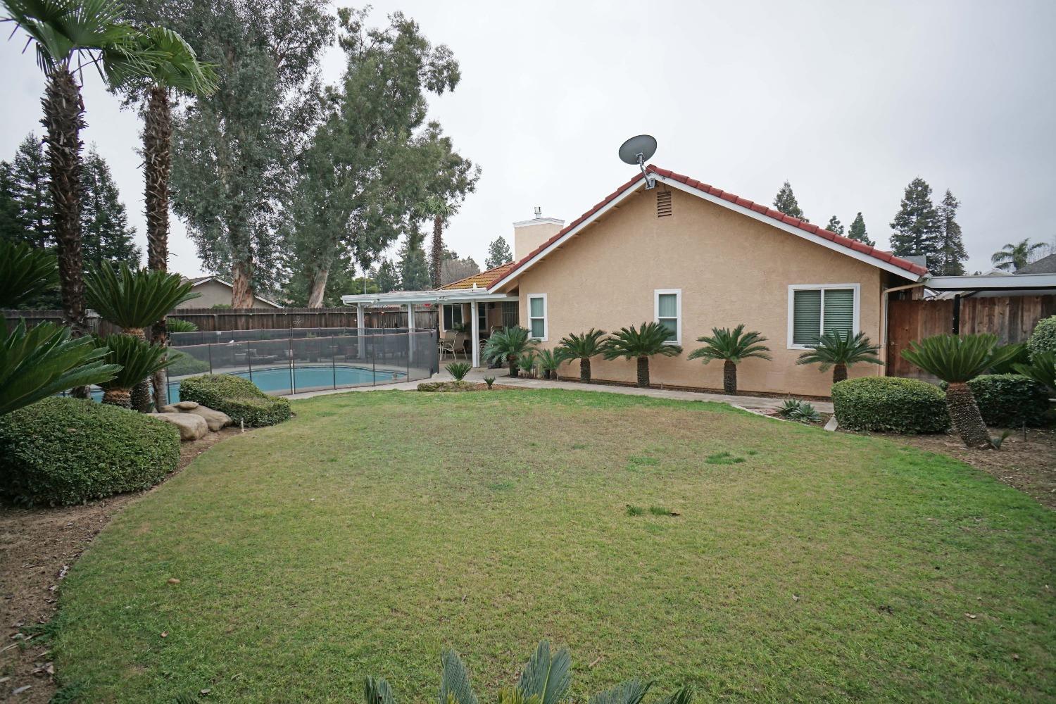 2197 Polson Avenue Clovis, CA 93611 - Photo 34 of 42 a view of a house with a backyard and a tree