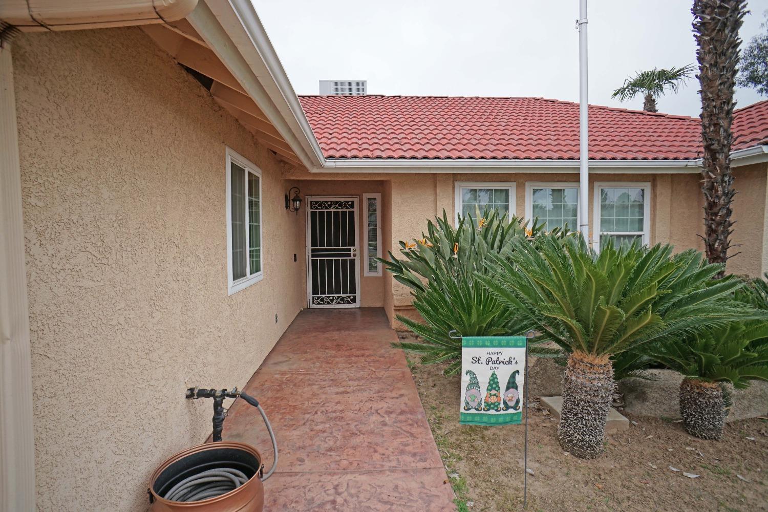 2197 Polson Avenue Clovis, CA 93611 - Photo 4 of 42 a view of a brick house with potted plants
