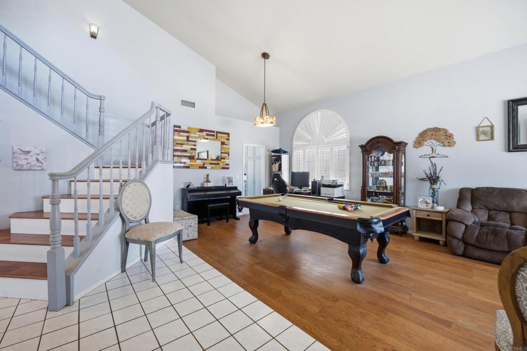 2077 Westwood Road Vista, CA 92083 - Photo 5 of 37 a living room with chairs a rug and a chandelier