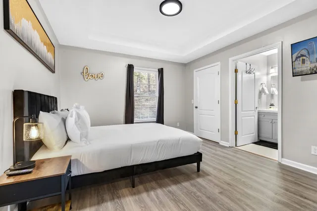 a bedroom with a bed and wooden floor